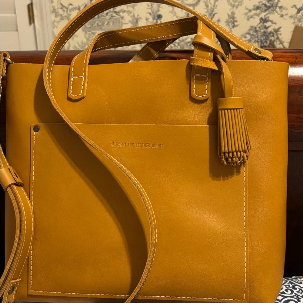 Portland Leather medium classic mango Crossbody Bag, with pom tassel